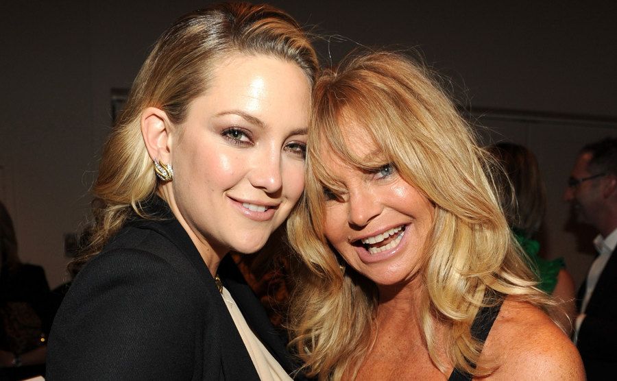 Kate Hudson and Goldie Hawn pose together backstage. 