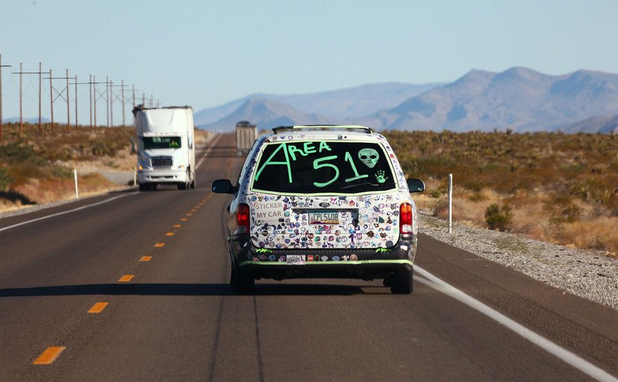 A car drives in Nevada with 'Area 51' written on the back.