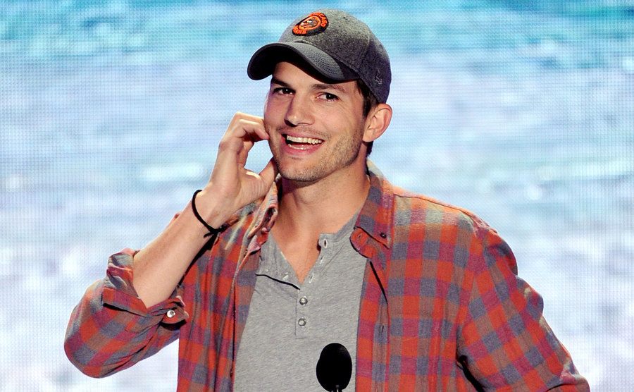 Ashton Kutcher speaks onstage at the Teen Choice Awards. 
