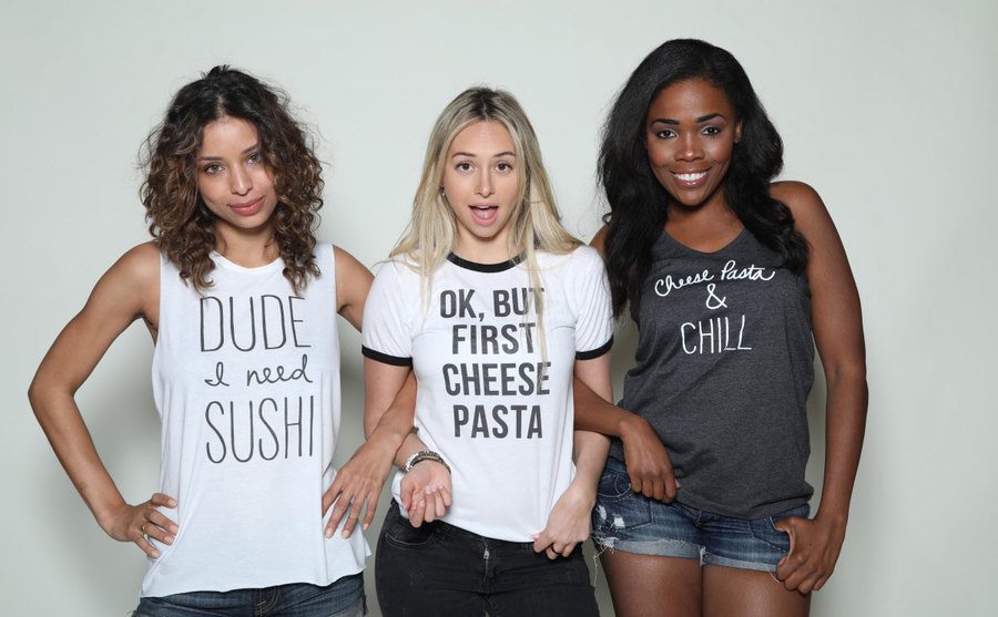 Corinne poses with models to promote her clothing line.