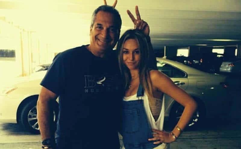 Olympios takes a photo with her father.