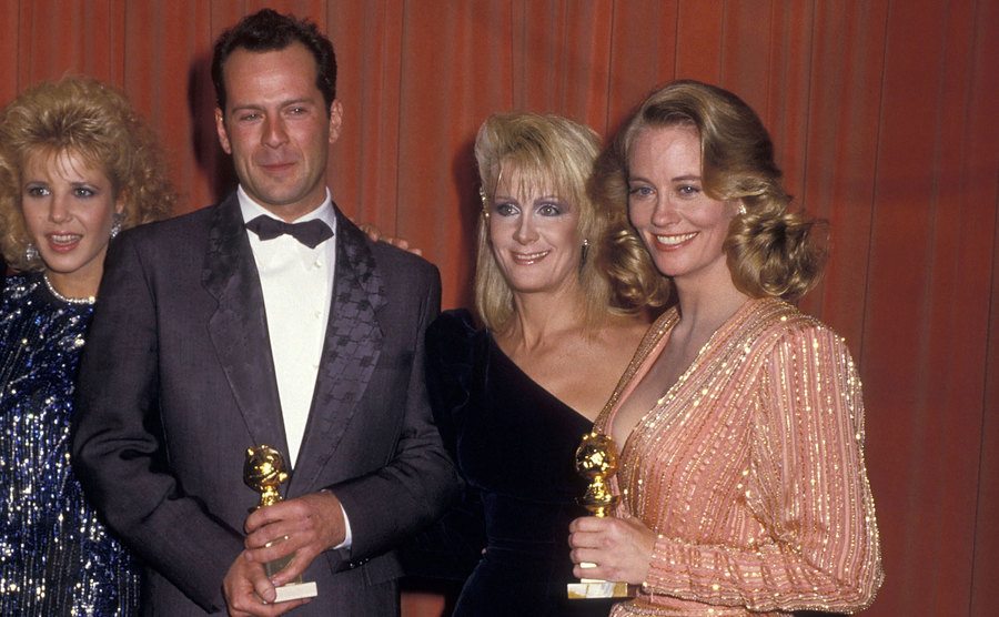 Bruce Willis, Joan Van Ark, and Cybill Shepherd pose backstage at the Golden Globe Awards. 