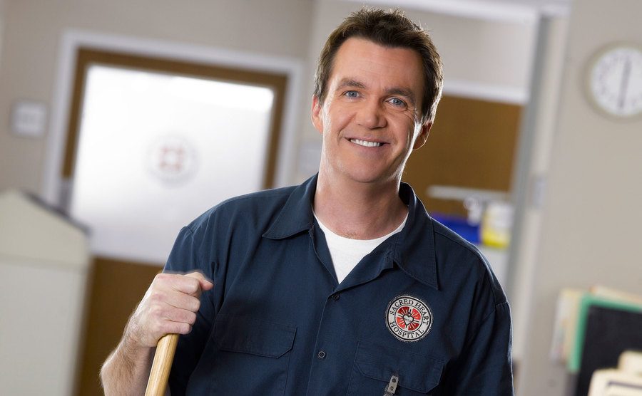 Neil Flynn, as the Janitor, poses on the set of Scrubs. 