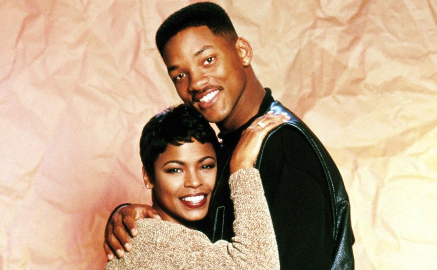 Will Smith and Nia Long pose for a studio portrait. 