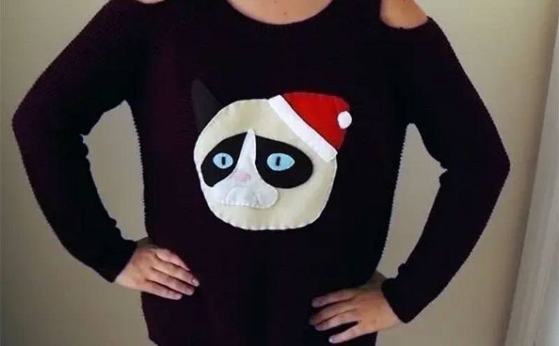 A sweater with a stitch of Grumpy Cat on it. 