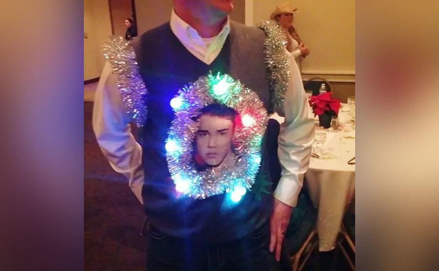 A sweater vest covered in tinsel and a picture of Justin Bieber 