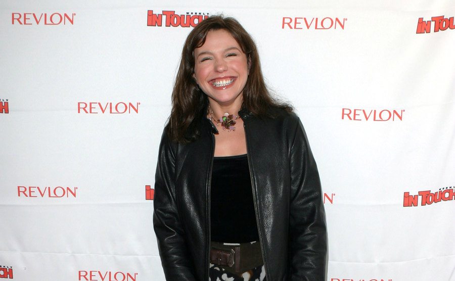Rachael Ray poses, smiling at the press.