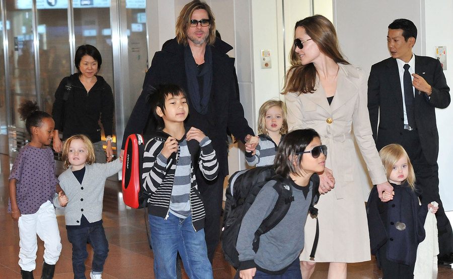 An early photo of Brad, Angelina, and their children at the airport.