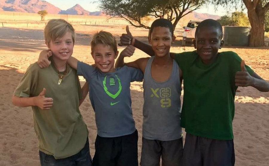 Shiloh takes a picture with other kids in Namibia