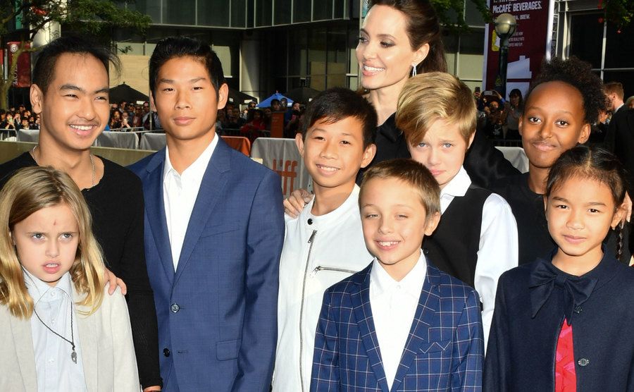 Angelina poses next to all of her children.