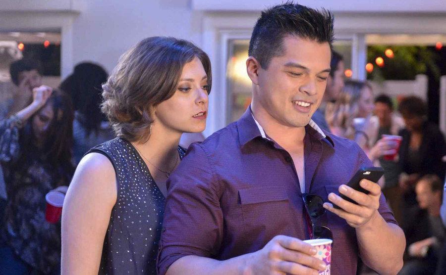 Rachel Bloom, as Rebecca Bunch, stares obsessively at Vincent Rodriguez III, as Josh Chan. 