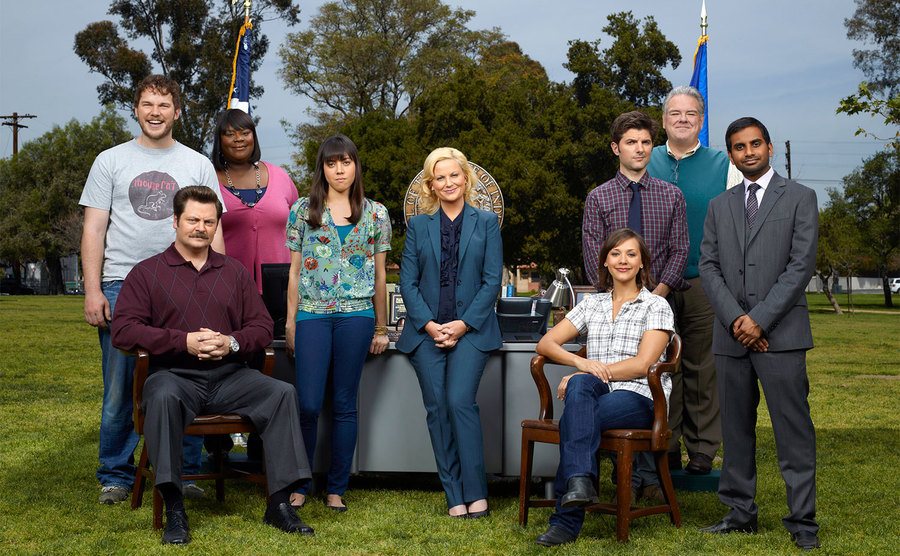 The cast of Parks and Recreation pose for a promo shot. 