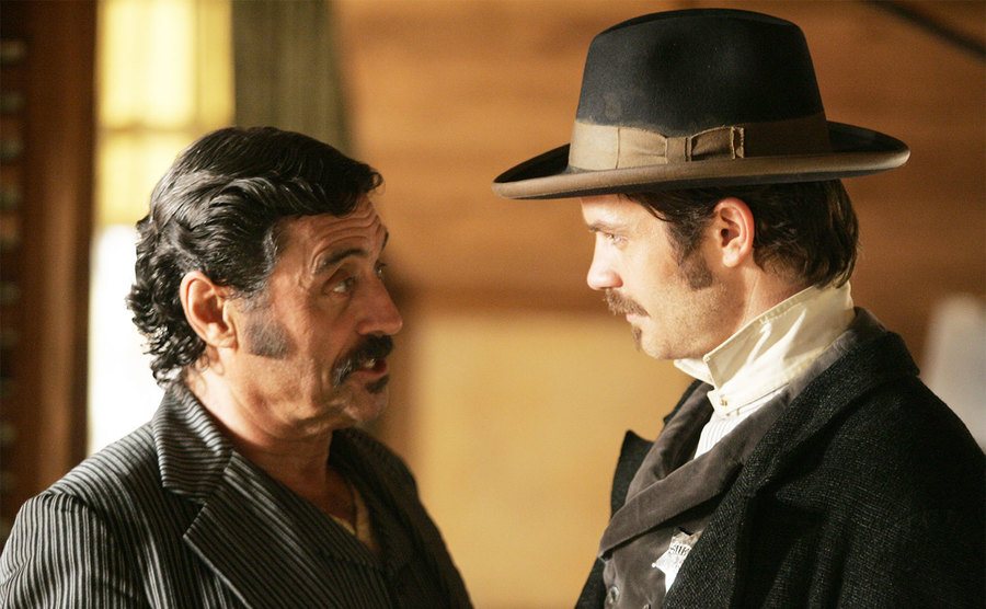 Timothy Olyphant and Ian McShane, as Seth Bullock and Al Swearengen, talk in a still from the show. 