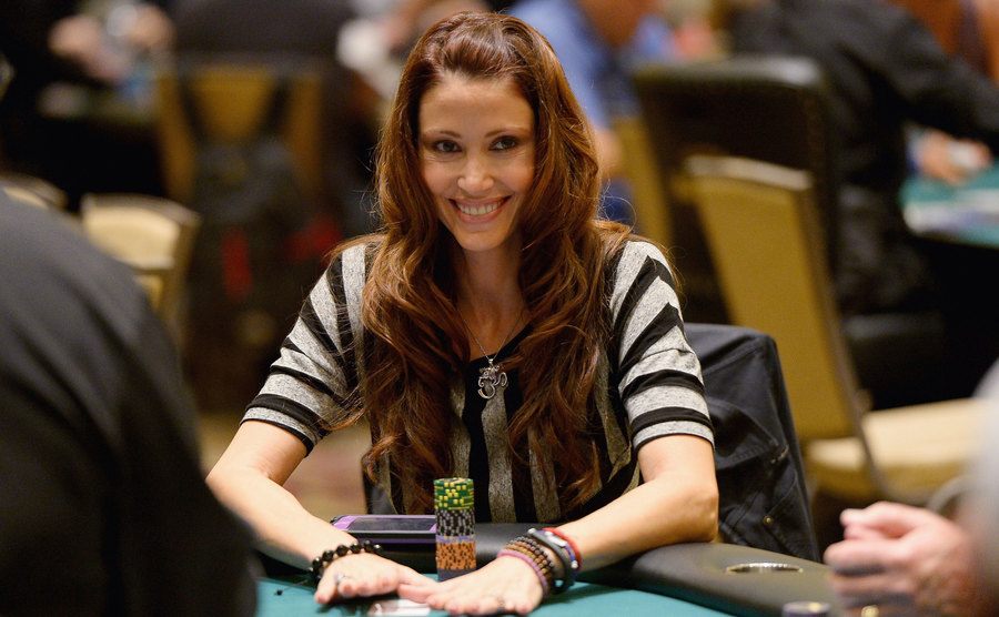 Shannon Elizabeth goes all in while sitting at a poker table. 