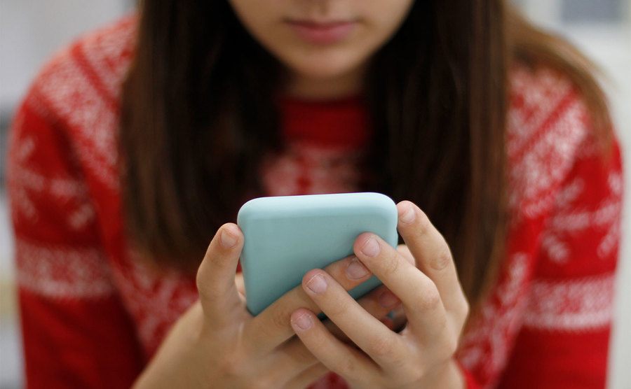 A young woman is using a smartphone. 