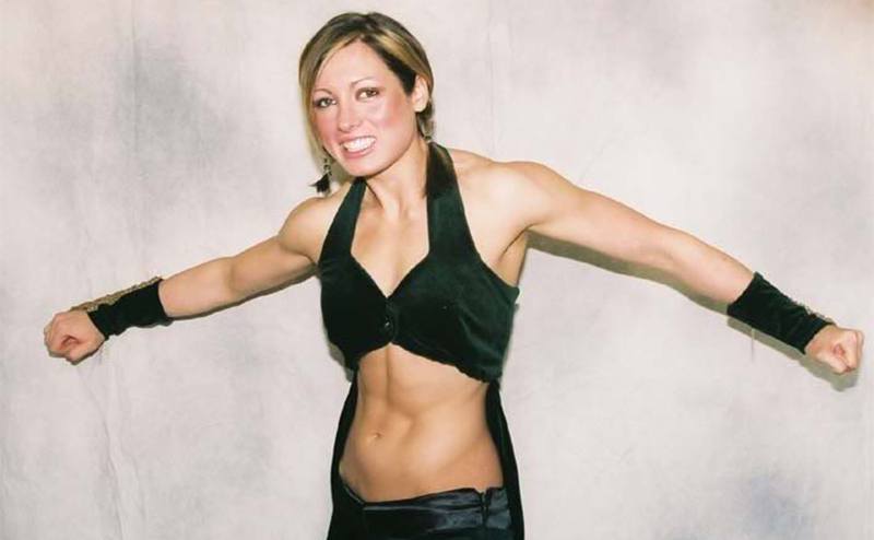 A very skinny-looking Becky Lynch poses for a picture. 