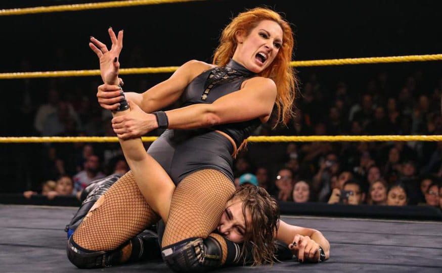 Becky Lynch is pinning down her opponent in the ring. 
