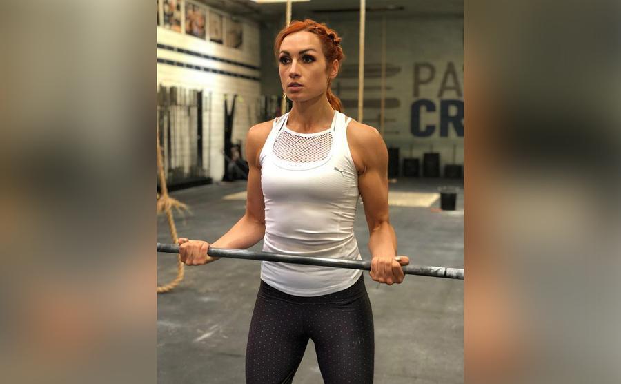 Becky is lifting weights at the gym. 
