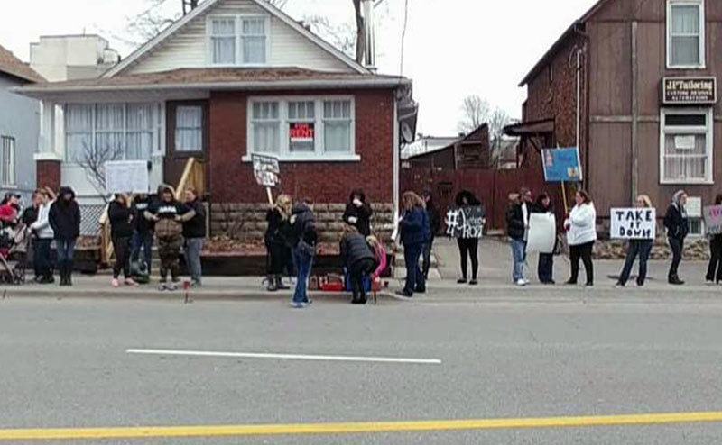 An image of citizens protesting outside Adam’s house.