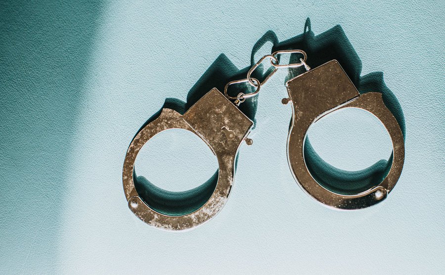 An image of shiny silver metal handcuffs.