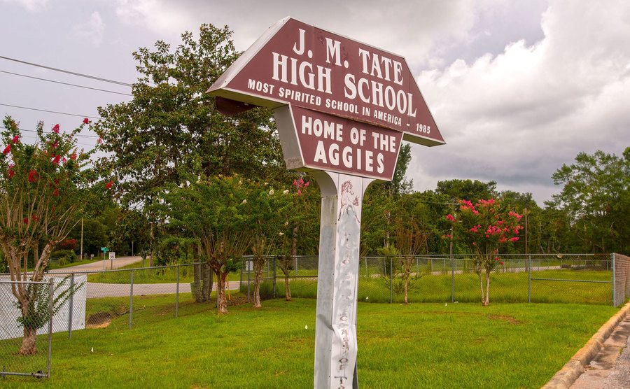A sign indicating the entrance to Tate High School.