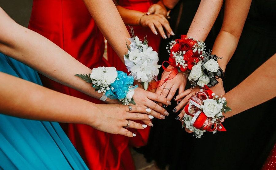 An image of girls showing their prom corsages.