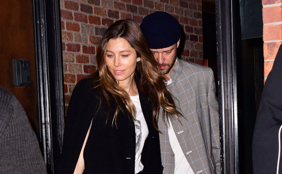 Jessica Biel and Justin Timberlake are exiting a restaurant.