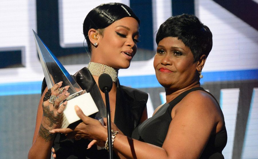 Rihanna and her mom speak on stage at the awards.