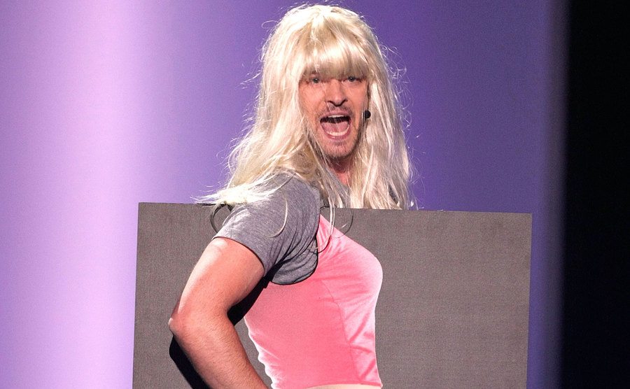 Justin Timberlake performs as he stands behind a Jessica Simpson cutout onstage.