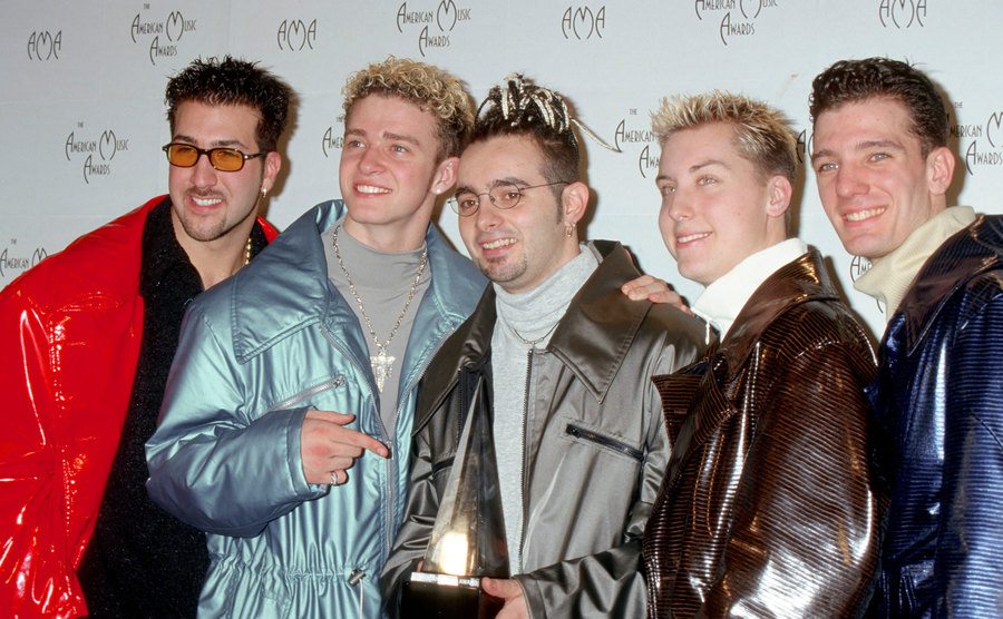 Joey Fatone Jr, Justin Timberlake, Chris Kirkpatrick, Lance Bass, and JC Chasez pose for a band portrait.