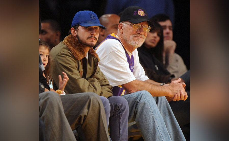 Shia and his father, Jeffrey, are at a basketball game. 