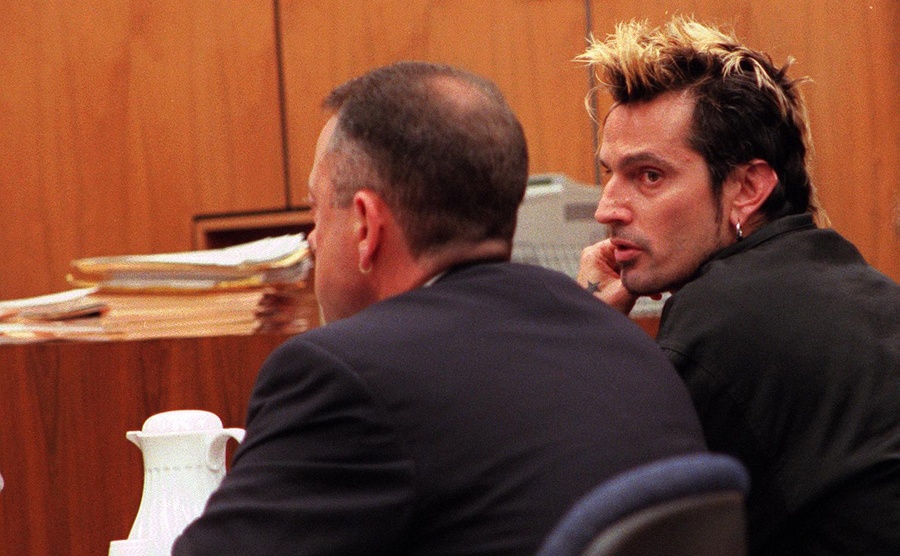 Tommy Lee sits in court with his lawyer. 