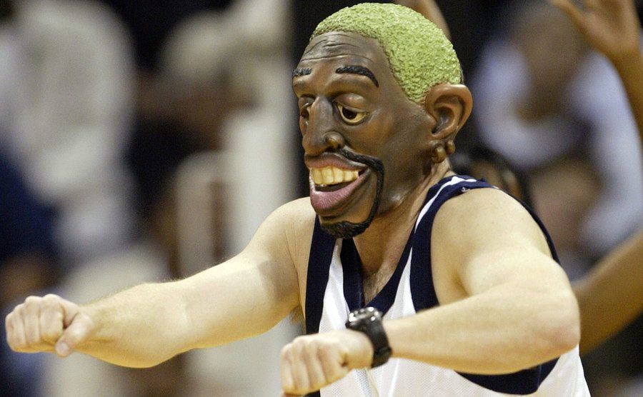 A fan wears a Dennis Rodman mask.