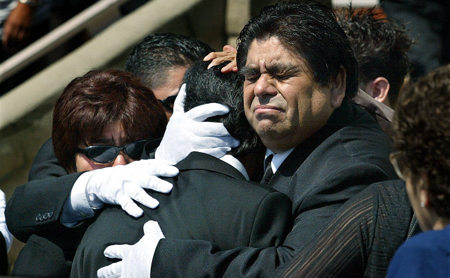 Marcelo’s relatives hug each other after the funeral.