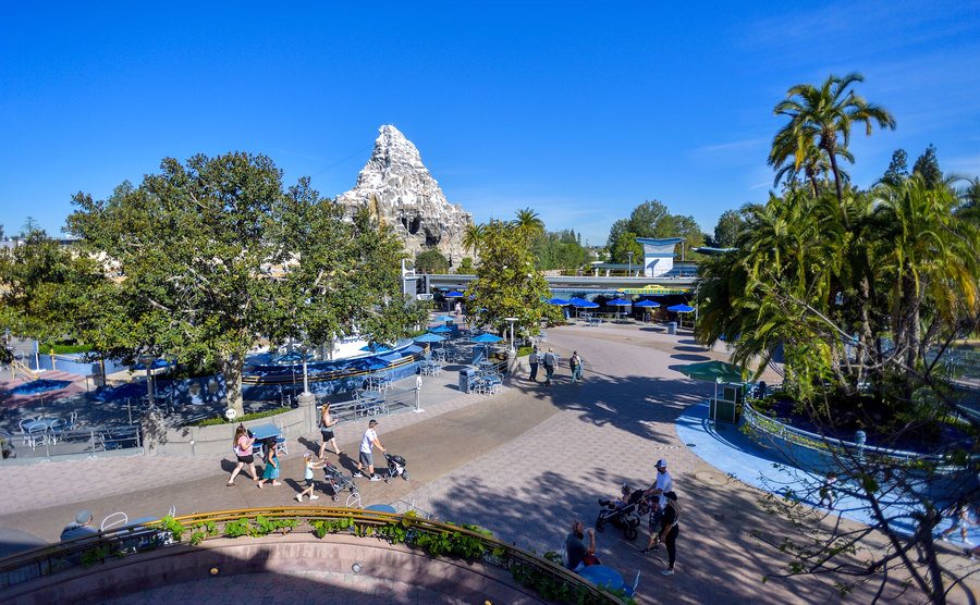 Visitors roam Tomorrowland at Disney.