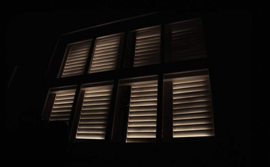 Light enters through a window in a dark room.