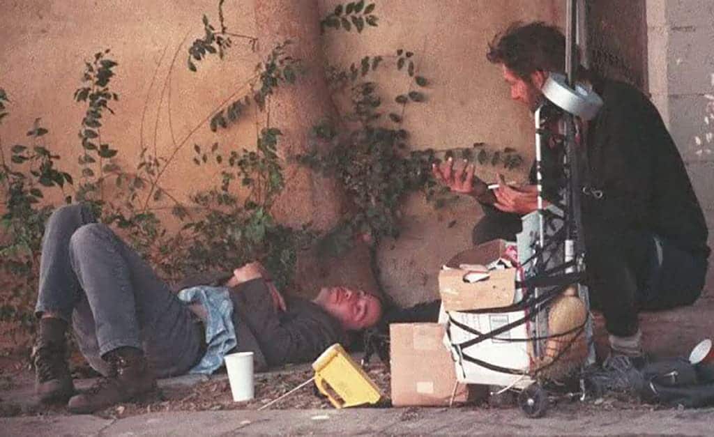 Keanu Reeves sitting with Homeless