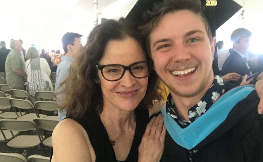Ally poses with her son at his graduation.