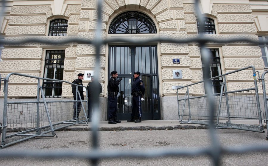 Austrian police stand guard in front of the court building.