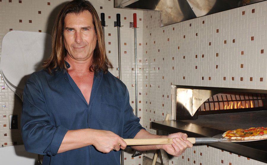 A picture of Fabio preparing pizza.