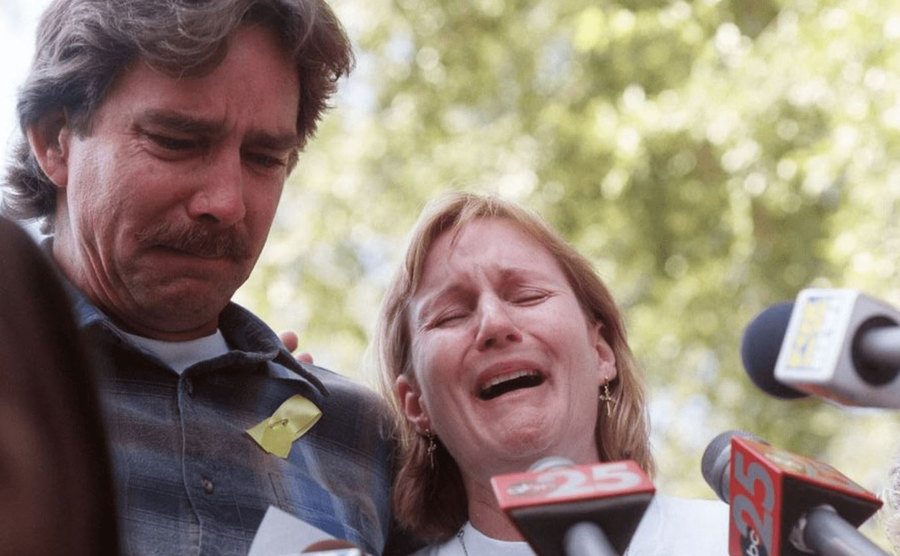 Maddie’s parents cry during a press conference in the neighborhood.