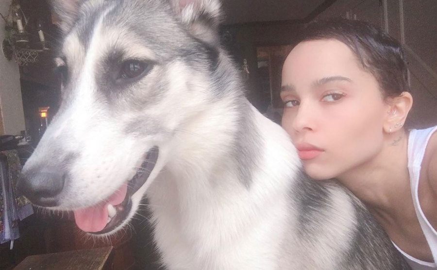Zoe takes a selfie with her dog at home. 