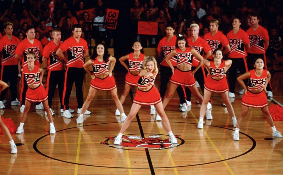 The cast of bring it on performs a cheer. 