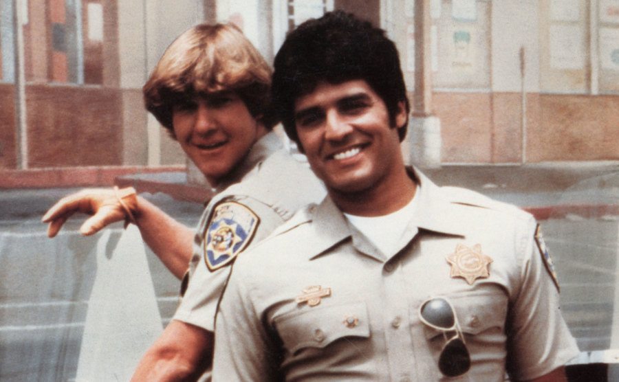 A photo of Wilcox and Estrada on set. 