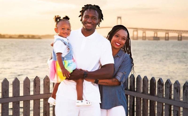 Jephte Pierre, Shawniece Jackson, and their daughter pose on the waterfront. 