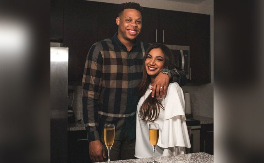Mia Bally and Tristan Thompson pose together in their kitchen. 