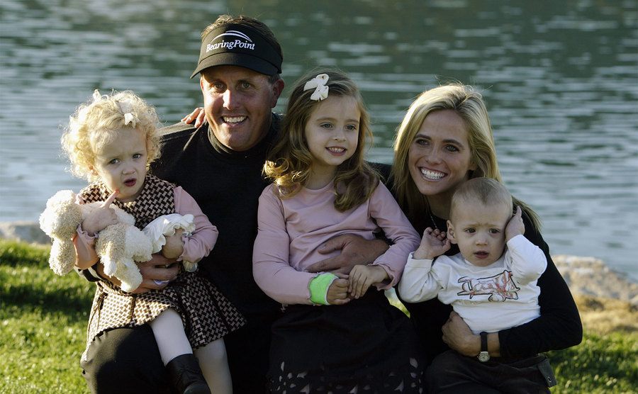 Phil Mickelson poses for a portrait with his wife Amy and their three children.