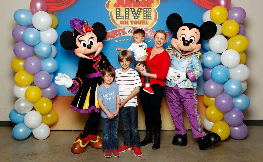 Brady, Mason, and Tucker Wilkerson, along with Melissa Joan Hart attend a Disney event. 