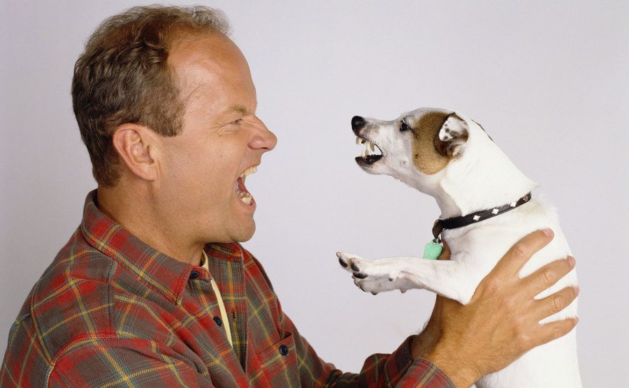 Kelsey Grammer, as Frasier Crane, holds his dog. 
