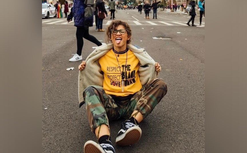 Zendaya sits in the middle of the street during the Women’s March as part of her support. 